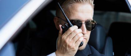 Man Talking On Walkie Talkie Man Sitting Inside Car Doing Surveillance Talking On Walkie Talkie